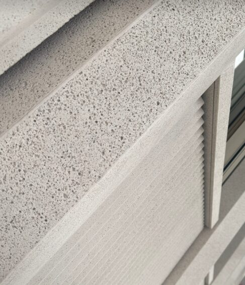 Détail de bardage minéral structuré.